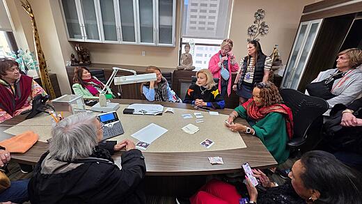 A tour group gathers around the table